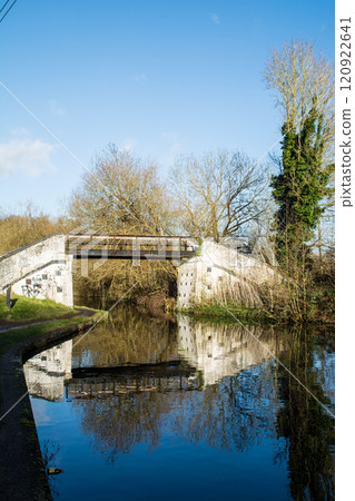 A stone and concrete footbridge spanning a canal in the Colne Valley on the outskirts of London A stone and concrete footbridge spanning a canal in the Colne Valley on the outskirts of London 120922641