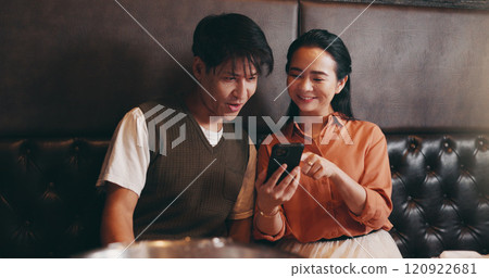 Japanese, couple and happy with smartphone for restaurant, online menu or service with conversation. Valentines day, man or woman with mobile application for digital order, options or bonding on date 120922681