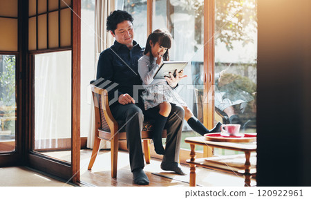 Education, reading or tablet with father and daughter on chair in home for child development or learning. Japanese family, study or tech with single parent man and girl in apartment for search Education, reading or tablet with father and daughter on chair in home for child development or learning. Japanese family, study or tech with single parent man and girl in apartment for search 120922961