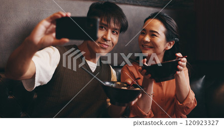 Couple, food and selfie on date in restaurant for happy memory, profile picture update or social media post. Japanese people, ramen bowl and smile with photography in cafe for bonding and nutrition Couple, food and selfie on date in restaurant for happy memory, profile picture update or social media post. Japanese people, ramen bowl and smile with photography in cafe for bonding and nutrition 120923327