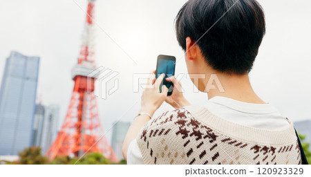 Tourism, photography and person with smartphone, city and capture of landmark, screen and content creation. Outdoor, influencer and tourist with mobile, display and picture of Tokyo Tower in Japan 120923329