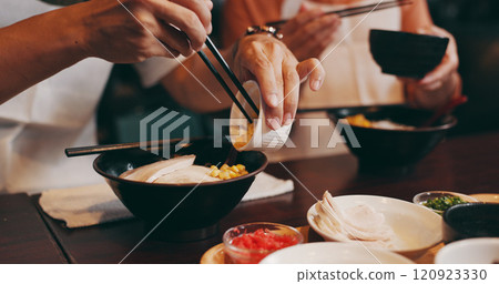 Couple, hands and eating with chopsticks in restaurant for healthy meal, ramen bowl and serving corn vegetables. Japanese people, noodles and food for traditional cuisine, lunch diet and gourmet dish 120923330