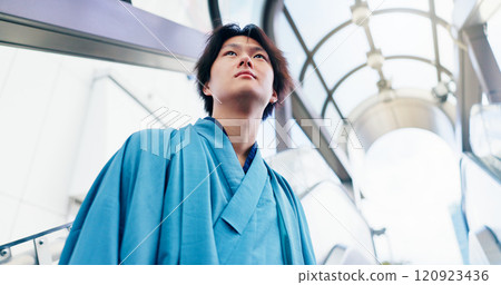 Man, thinking and escalator with traditional clothes, outfit and yukata for heritage. Japanese guy, holiday and pride for culture, journey and sightseeing with casual dress kimono fashion in city Man, thinking and escalator with traditional clothes, outfit and yukata for heritage. Japanese guy, holiday and pride for culture, journey and sightseeing with casual dress kimono fashion in city 120923436