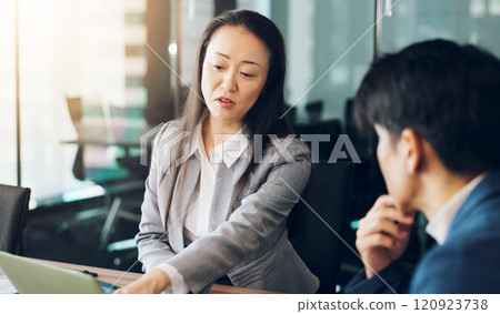 Business, discussion or Asian people in meeting pointing for investment or revenue information. Woman, talking or sales review with man or technology for planning project, agenda and budget in Japan Business, discussion or Asian people in meeting pointing for investment or revenue information. Woman, talking or sales review with man or technology for planning project, agenda and budget in Japan 120923738