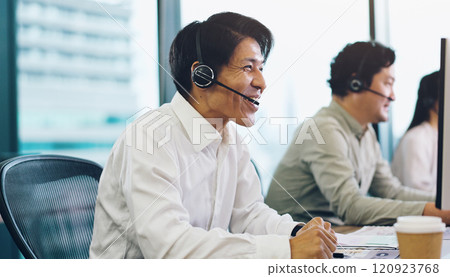 Customer service, call center and Asian man on computer in office for contact, online help and consulting. Coworking, technology and Japanese people for communication, CRM support and telemarketing 120923768
