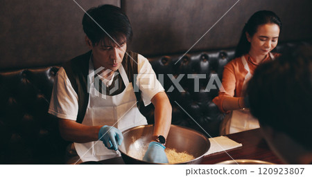 Cooking, man and woman in class with chef, romantic date and bonding together at Asian food restaurant. Couple, learning and making noodles at cafe with teacher, culinary course and Japanese culture Cooking, man and woman in class with chef, romantic date and bonding together at Asian food restaurant. Couple, learning and making noodles at cafe with teacher, culinary course and Japanese culture 120923807