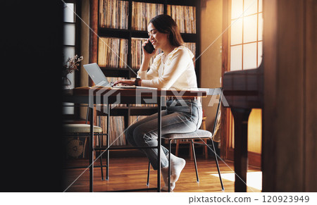 Woman, smile and phone call at laptop for remote work, planning or negotiation feedback in home. Japanese person, tech or contact at table for discussion, brainstorming or consultation for networking 120923949