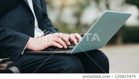 Laptop, businessman and hands typing at park for remote work, research or environmental consultant writing email. Employee, online and computer in city closeup for sustainable project review in Japan 120923974