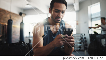 Fitness, gym and man with phone rest for social media, internet and online message. Athlete, health and person on smartphone on break with mobile app for exercise, training and workout progress Fitness, gym and man with phone rest for social media, internet and online message. Athlete, health and person on smartphone on break with mobile app for exercise, training and workout progress 120924154
