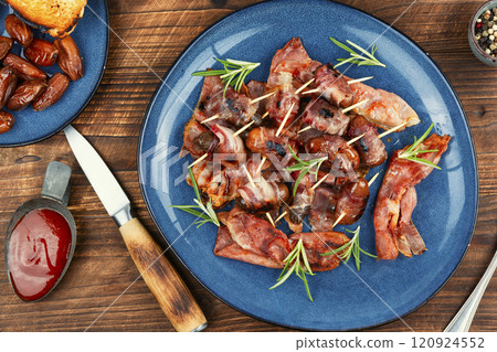 Elegant appetizer featuring bacon-wrapped dates. Elegant appetizer featuring bacon-wrapped dates. 120924552