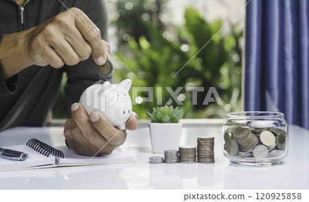 Hand with money coins in clear glass, Business investment growth concept, saving concept, Hand putting coin in clear jar. Hand with money coins in clear glass, Business investment growth concept, saving concept, Hand putting coin in clear jar. 120925858