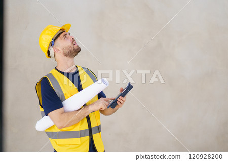 Senior professional caucasian white male real estate foreman inspecting inside the building construction, foreman checking the under construction building. Caucasian male engineer inspects interior. Senior professional caucasian white male real estate foreman inspecting inside the building construction, foreman checking the under construction building. Caucasian male engineer inspects interior. 120928200