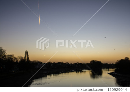 The River Thames reflecting the pre-dawn glow and a streetscape lined with winter trees and street lamps in Kew Bridge, a suburb of London The River Thames reflecting the pre-dawn glow and a streetscape lined with winter trees and street lamps in Kew Bridge, a suburb of London 120929044