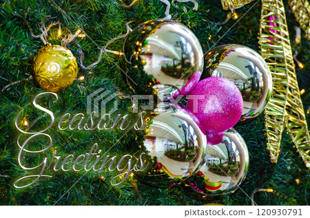 Season Greetings Wishes text with Christmas ball and pine tree background. Christmas celebration concept 120930791