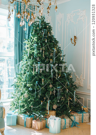 Decorated Christmas tree with presents in a cozy indoor setting during holiday season Decorated Christmas tree with presents in a cozy indoor setting during holiday season 120931328