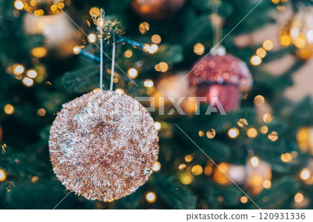 Beautifully decorated Christmas tree adorned with shimmering ornaments and bright lights background 120931336
