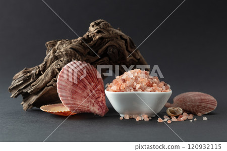 Pink himalayan salt with snags and seashells on a black background. Pink himalayan salt with snags and seashells on a black background. 120932115