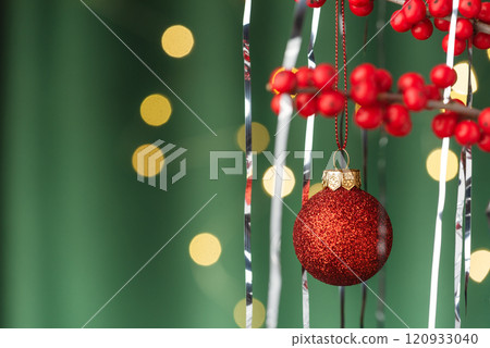 Green Background with Ilex, Christmas Balls, and Tinsel Green Background with Ilex, Christmas Balls, and Tinsel 120933040