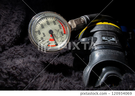 Scuba diving pressure gauge and a second stage air regulator close up 120934069