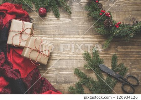 Christmas composition of wreath, gifts on wooden board. Xmas card 120934126