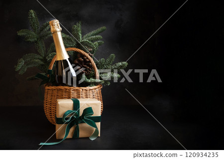 Christmas holiday gift hamper with sparkling wine and gift on black. 120934235