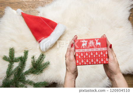 Female hand holding Christmas gift box. Holiday concept. Winter. Female hand holding Christmas gift box. Holiday concept. Winter. 120934510