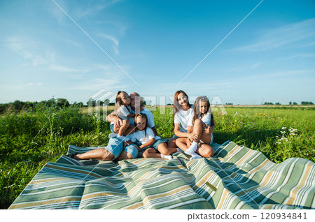 Farmer family with little daughter walking through grass field. Mom dad girl walking together holding hands 120934841