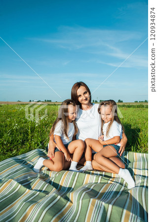 A mother and her daughter are having fun in a field. A mother and her daughter are having fun in a field. 120934874