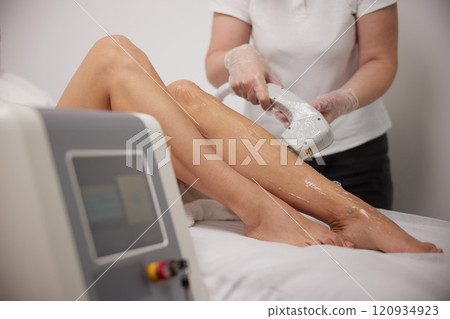 cosmetology procedure, woman's legs, laser epilation. Getting hair removed on legs, Laser treatment on leg at spa, Laser epilation and cosmetology, Cosmetology SPA concept, Laser epilation cosmetology cosmetology procedure, woman's legs, laser epilation. Getting hair removed on legs, Laser treatment on leg at spa, Laser epilation and cosmetology, Cosmetology SPA concept, Laser epilation cosmetology 120934923
