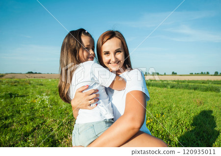 The mother is holding a baby girl. 120935011