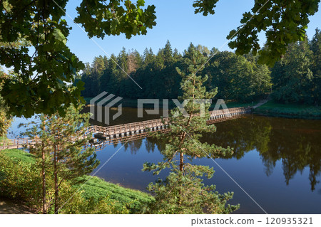 Pedestrian pontoon bridge over the Ogre River in the town of Ogre, Latvia. Pedestrian pontoon bridge over the Ogre River in the town of Ogre, Latvia. 120935321