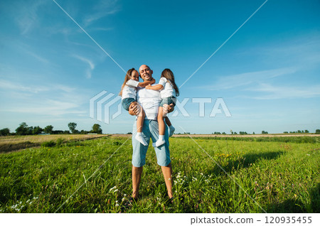 Happy kids dad and mom are kissing and hugging. 120935455