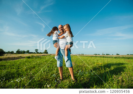 Happy kids dad and mom are kissing and hugging. 120935456