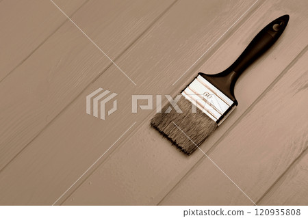 Paintbrush lying on wooden planks in Mocha and Mousse color scheme Paintbrush lying on wooden planks in Mocha and Mousse color scheme 120935808