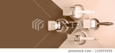 Top view of paint brushes on cans with various shades of brown Top view of paint brushes on cans with various shades of brown 120935856