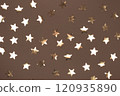 Golden star pattern on a mocha and mousse background for festive decor 120935890