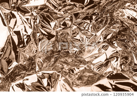 Reflective metallic foil with brown sepia tones in detailed close-up view Reflective metallic foil with brown sepia tones in detailed close-up view 120935904