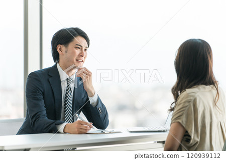 A businessman serving at an investment trust, money consultation, and individual consultation session and a female client receiving counseling A businessman serving at an investment trust, money consultation, and individual consultation session and a female client receiving counseling 120939112