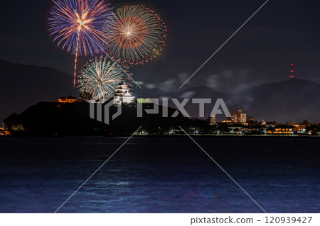 Karatsu City, Saga Prefecture - Fireworks at illuminated Karatsu Castle in autumn seen from the sea - Comparative light composition 120939427