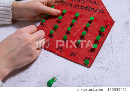 Wooden Christmas advent calendar in shape of house Gift idea. Do it yourself instruction eco-friendly decoration. Zero waste Making handmade presents children's diy projects. Holiday family time 120939431