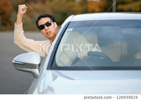 Angry man driving a car 120939819
