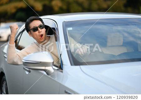 Angry man driving a car 120939820