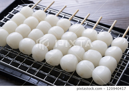 Grilling skewers of rice dumplings on a charcoal grill Grilling mitarashi rice dumplings Grilling skewers of rice dumplings on a charcoal grill Grilling mitarashi rice dumplings 120940417