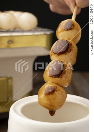 Mitarashi dango: Grilled dumplings dipped in sauce 120940449