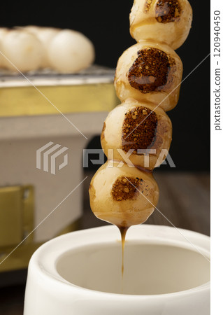 Mitarashi dango: Grilled dumplings dipped in sauce Mitarashi dango: Grilled dumplings dipped in sauce 120940450