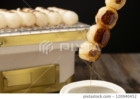 Mitarashi dango: Grilled dumplings dipped in sauce Mitarashi dango: Grilled dumplings dipped in sauce 120940452