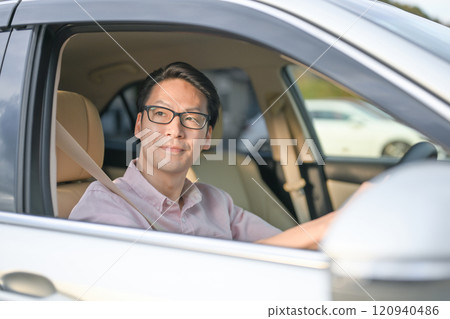 A man driving a car A man driving a car 120940486