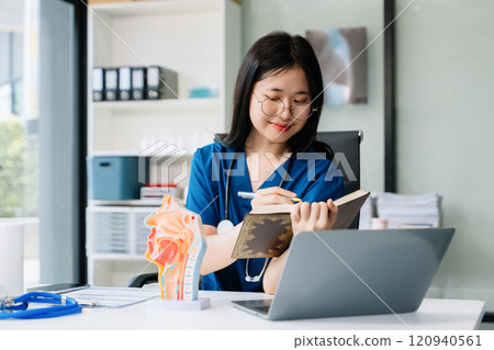 Beautiful physician doctor sit on table in office hospital. Attractive therapist female practitioner pharmacist smile 120940561