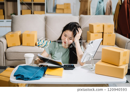 Asian owner woman prepare parcel box woman is stressed, bored, and overthinking from working and standing check online orders for deliver to customer. Asian owner woman prepare parcel box woman is stressed, bored, and overthinking from working and standing check online orders for deliver to customer. 120940593