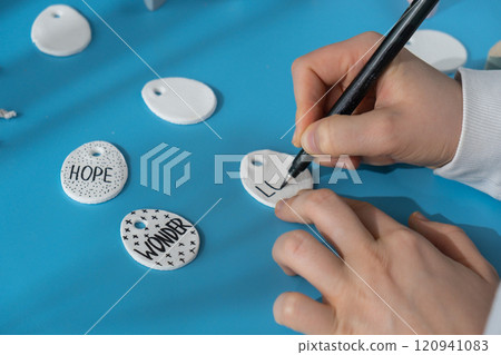 Master class writing word LOVE on EASTER egg Unrecognizable artist do it yourself air dry clay crafts for Easter holiday. Decoration gift idea Handmade children craft. Step by step instruction of 120941083